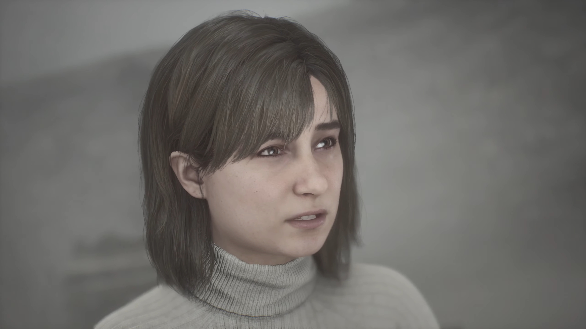 Das Gesicht einer Frau mit dunklen Haaren und in einem hellen Rollkragen-Pullover